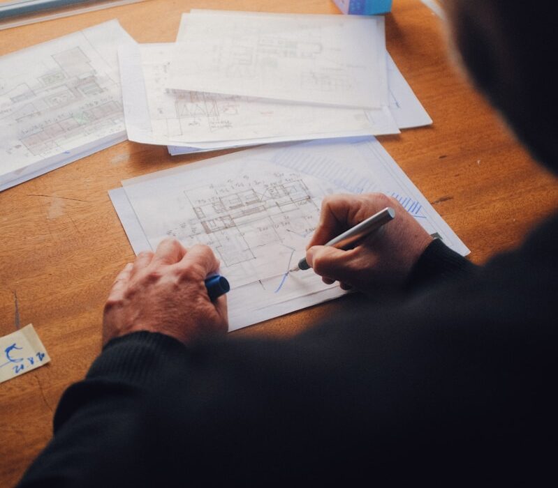 person writing on white paper