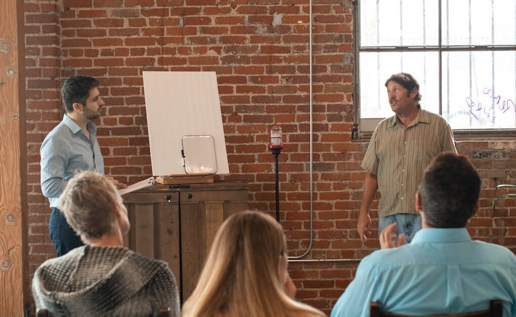 Adults attending a casual learning session in a rustic brick interior.