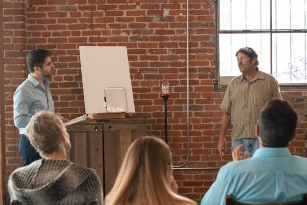 Adults attending a casual learning session in a rustic brick interior.